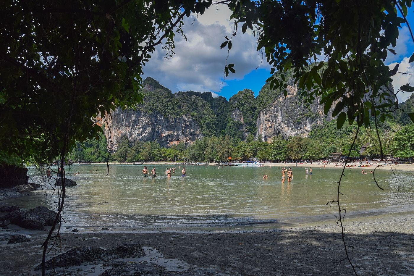 Railay West beach with longtail boats and limestone cliffs