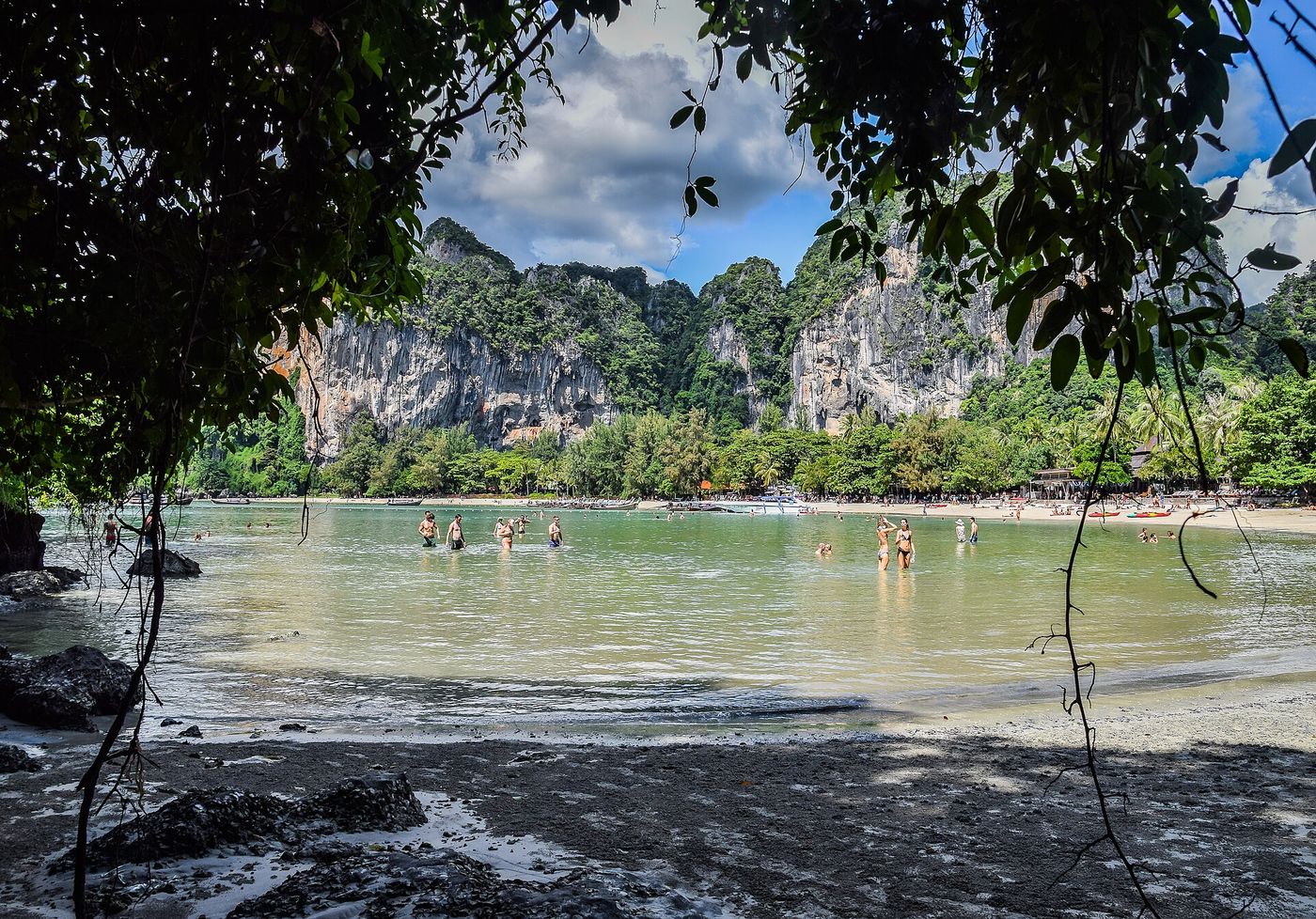Railay West beach with fine white sand and limestone cliffs at the end